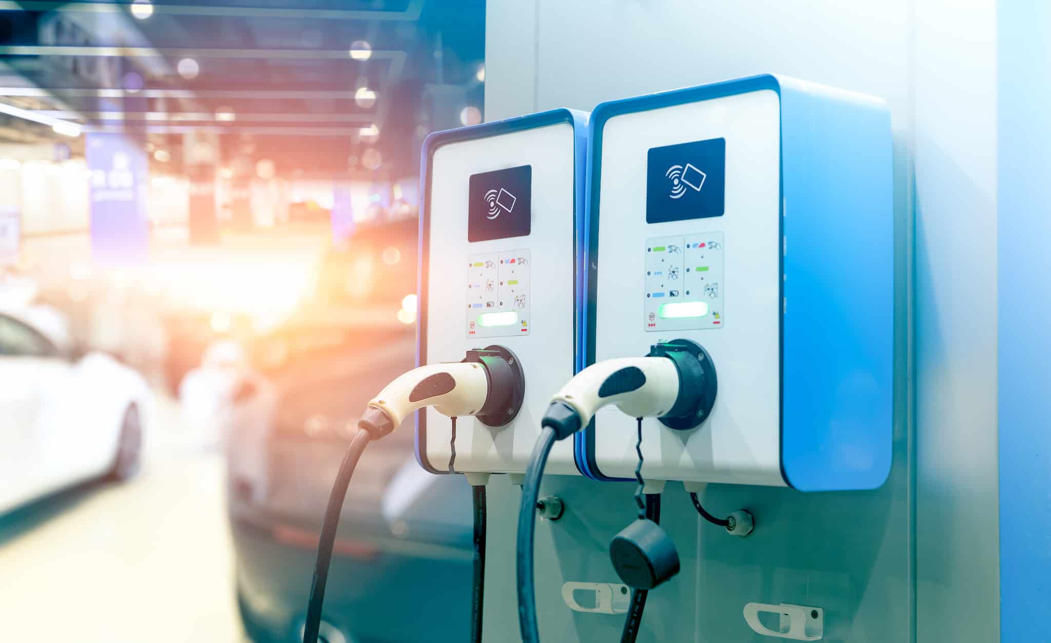 Electric car charging station for charge EV battery. Plug for vehicle with electric engine. EV charger station. Clean energy. Charging point for EV car. Green power. Future transport technology.